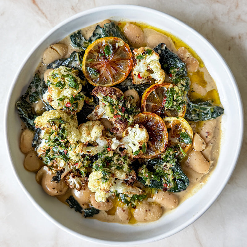 Dish photo for Creamy Butter Beans With Burnt Lemon & Mustard Sauce, Wilted Greens, Charred Cauliflower & Green Olive Salsa