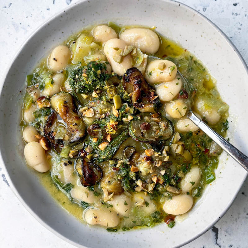 Dish photo for Creamy Butter Beans With Caramelised Leeks, Charred Courgettes, Drizzled With Olive & Almond Pesto