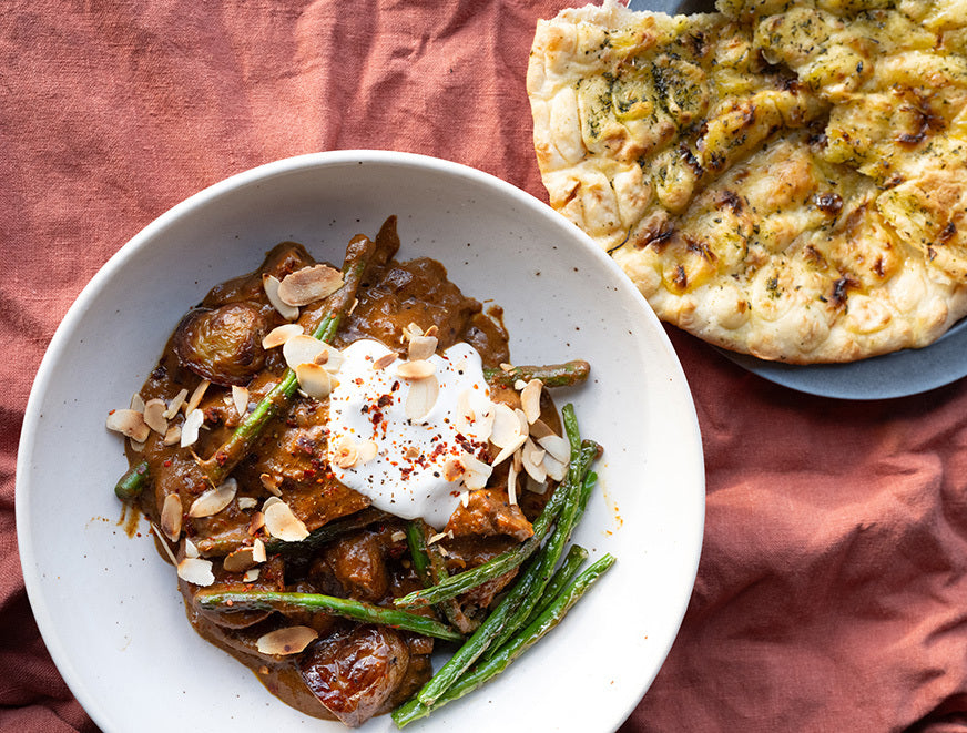 Dish photo for Massaman Tofu & Potato Curry With Toasted Flaked Almonds, Organic Cultured Yoghurt, Blistered Green Beans & Garlic Naan