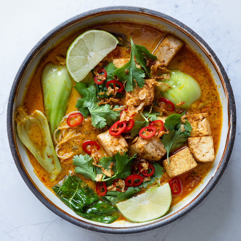 Dish photo for Rich & Fragrant Laksa With Tofu, Pak Choi, Vermicelli Noodles, Crispy Shallots, Chilli, Coriander & Lime
