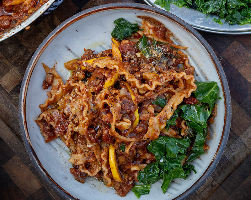 Dish photo for High Protein Tempeh Bolognese With Mafaldine Pasta, Courgettes, Kale, Pine Nut & Walnut 'Parmesan'