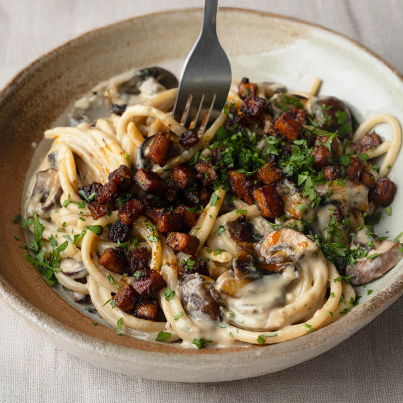 Dish photo for High Protein Creamy Garlic Bucatini With Chestnut Mushrooms, Crispy Tempeh 'Pancetta' & Fresh Parsley