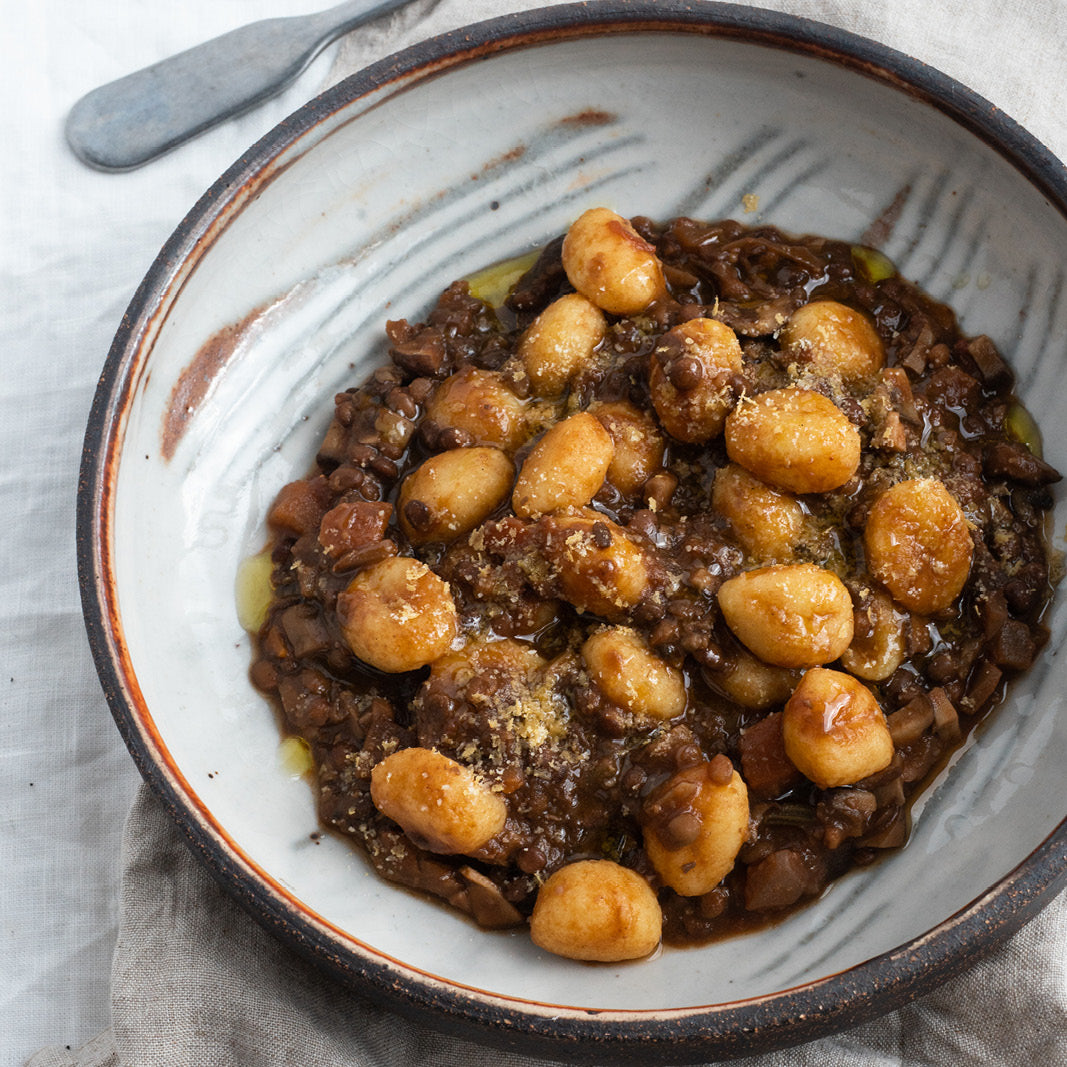 Dish photo for Freshly Made Gnocchi Tossed In A Rich Porcini Lentil Ragu With Almond Parmesan