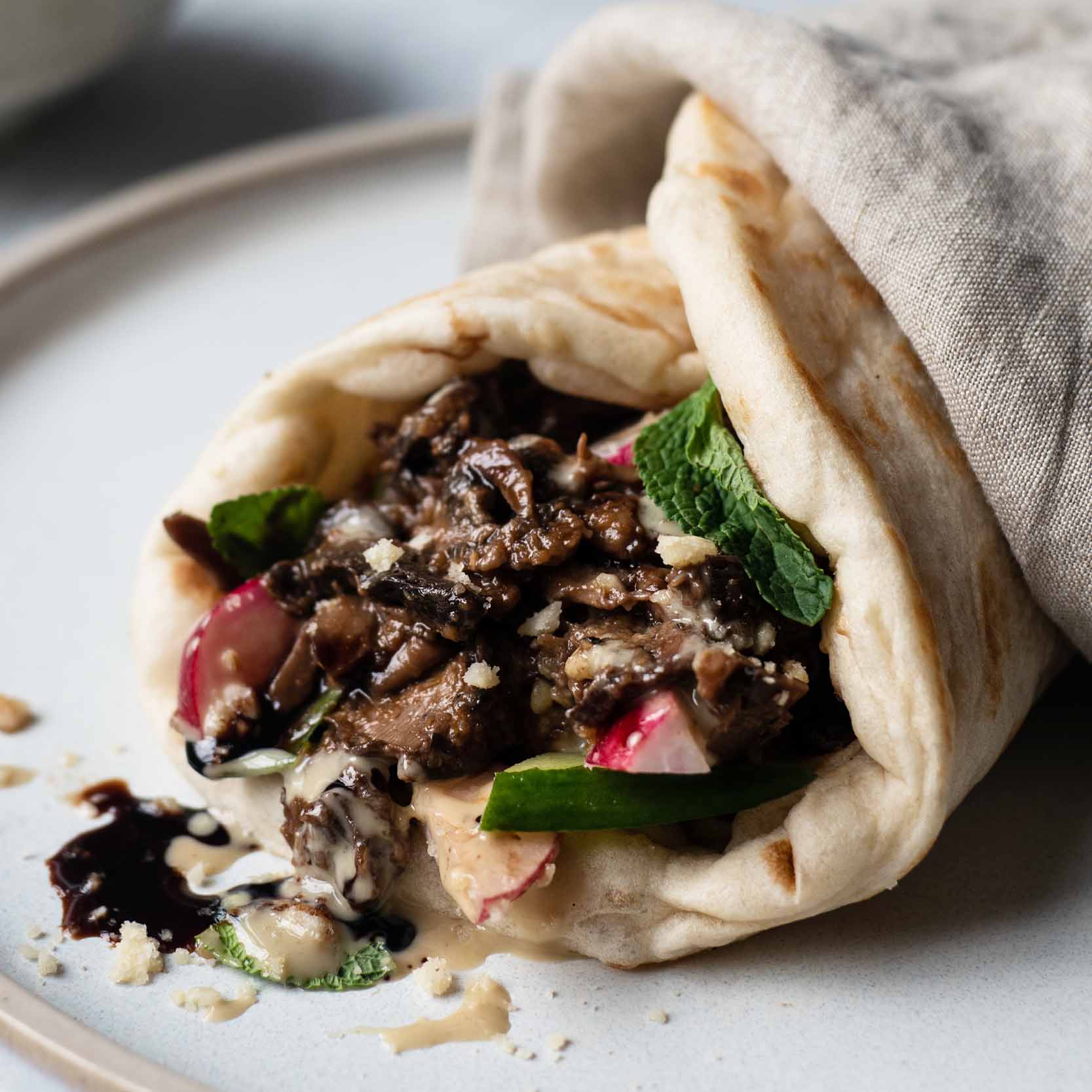 Dish photo for Crispy Mushroom Shawarma With Garlic Tahini Sauce, Pickled Radish & Fresh Mint In Soft Flatbread