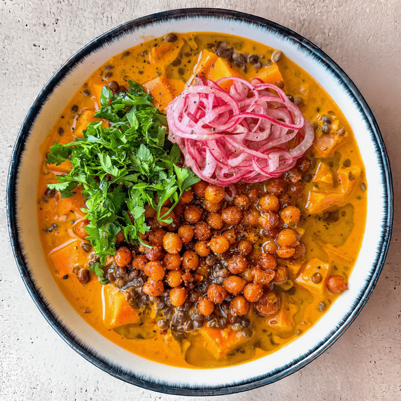 Dish photo for High Protein Thai Red Curry Lentil Soup With Sweet Potato, Smoky Crispy Chickpeas & Pink Onion Pickle