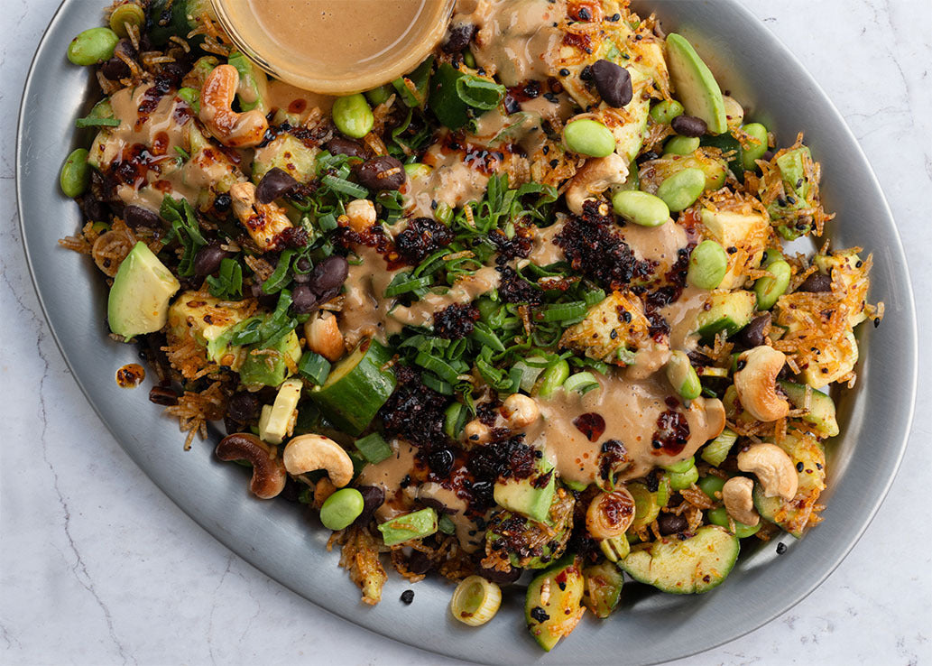 Dish photo for Crispy Rice Salad With Smacked Cucumber, Avocado, Edamame, Black Beans, Toasted Cashews, Chilli & Satay Dressing