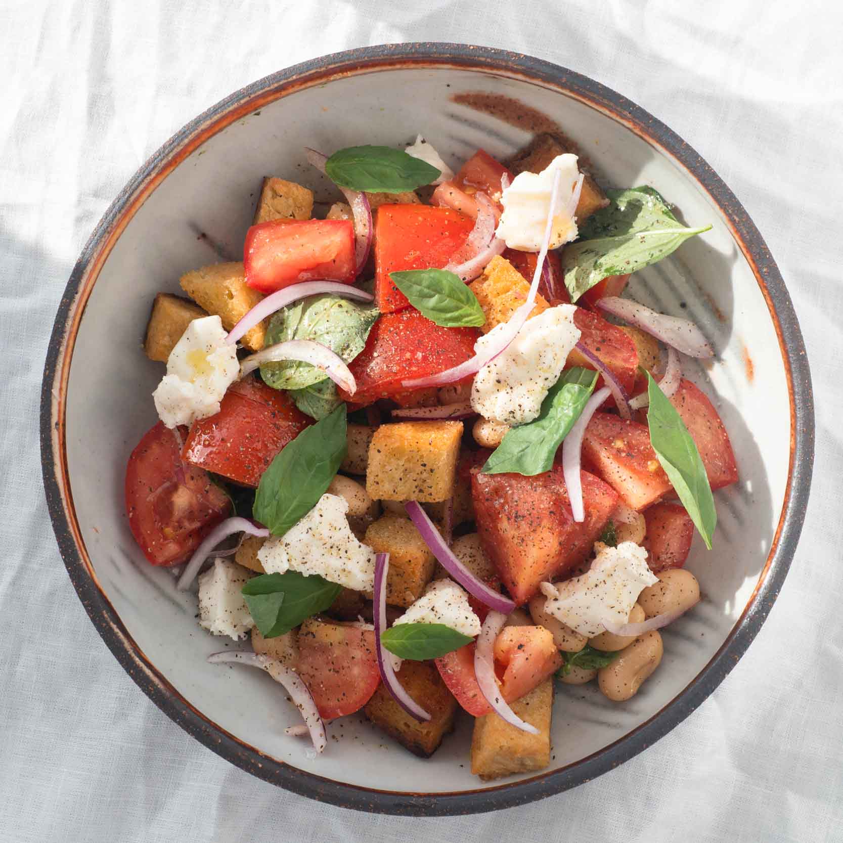 Dish photo for Tuscan Panzanella Salad, With Creamy Vegan Mozzarella, Golden Ciabatta Croutons & Caper-Spiked Vinaigrette