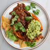 Superfood Black Bean Chilli Over Roasted Sweet Potato With Zingy Guacamole & Crunchy Tortilla Chips