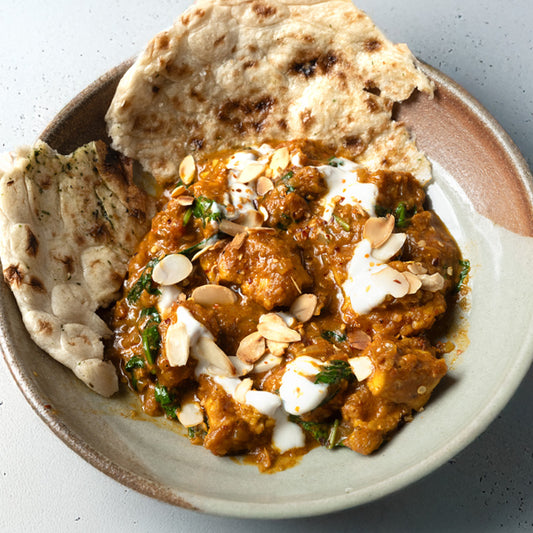 Rich & Creamy Tofu Butter 'Chicken' With Baby Spinach, Garlic Naan & Toasted Almond Flakes