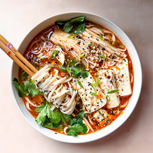 Kimchi Noodle Soup With Enoki Mushrooms, Tender Silken Tofu, Sesame Gochugaru Topping & Fresh Coriander