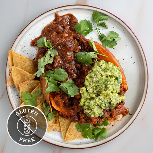 Superfood Black Bean Chilli Over Roasted Sweet Potato With Zingy Guacamole & Crunchy Tortilla Chips