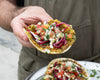 Smashed Falafel Tacos With Garlic Tahini Sauce, Sumac Cabbage Onion Pickle & Fresh Salad On Regenerative Wheat Tortillas